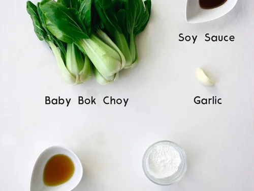 Ingredients for baby bok choy laid out and labeled -- bok choy, soy sauce, garlic, sesame oil, and corn starch