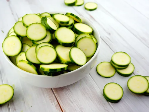 A bowl piled with thin raw zucchini slices