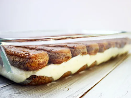 Side view of tiramisu showing layers of espresso-soaked ladyfingers and mascarpone filling